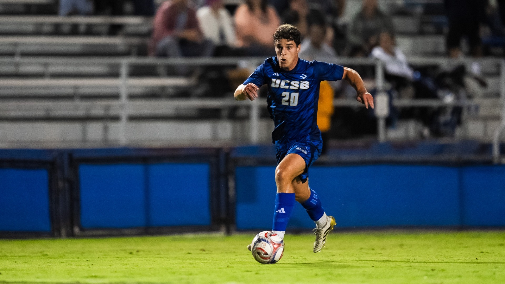 #20 Jack Middleton dribbles down the field at Harder Stadium