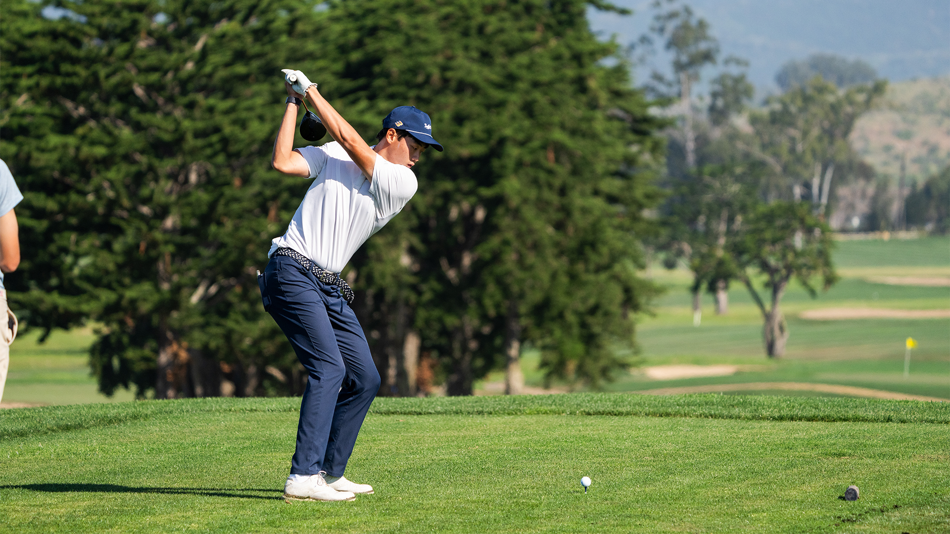 Dylan Ma takes a back swing as he begins to drive the ball on a hole. 