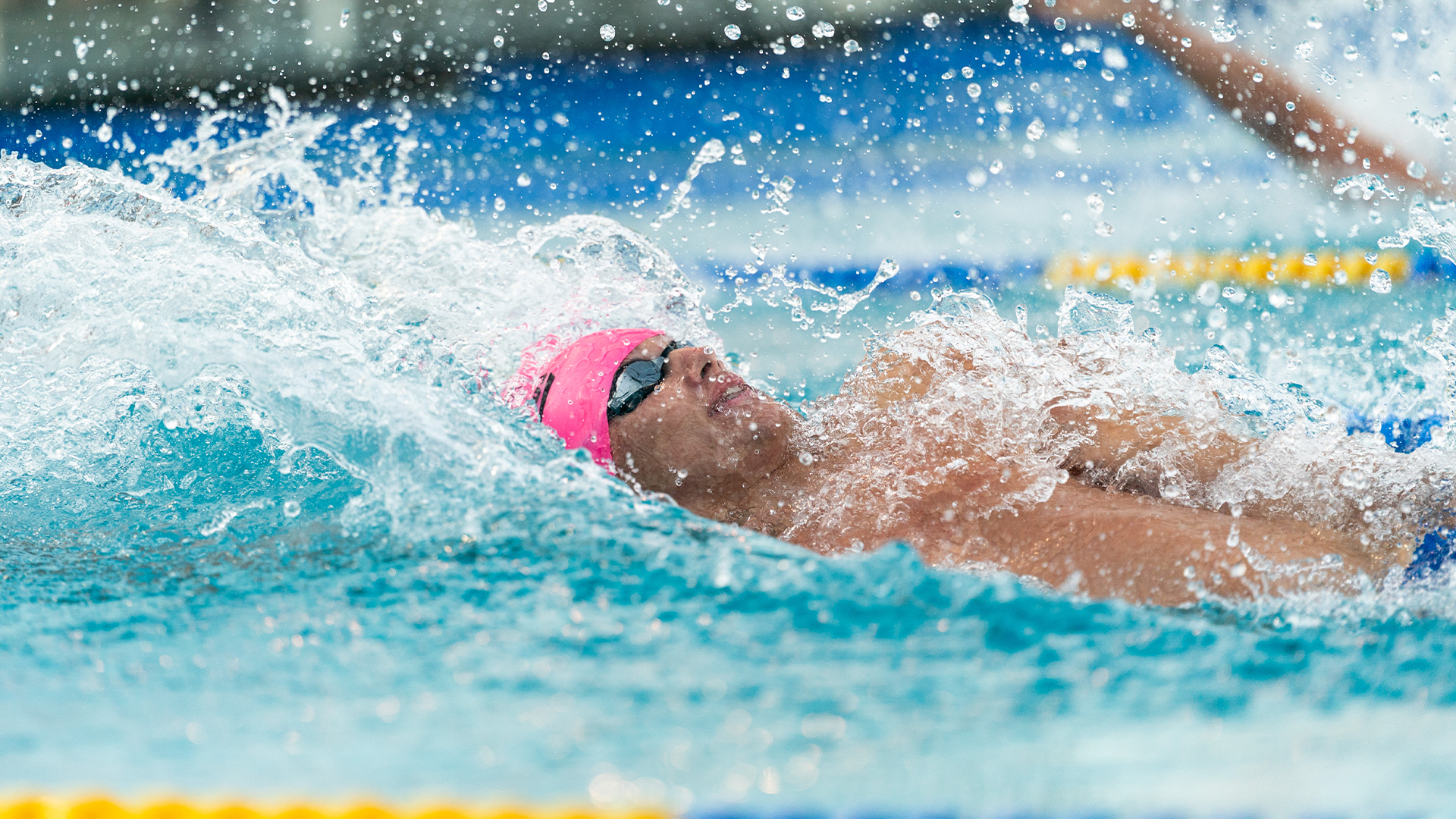 Men's Swimming backstrokes close up of student-athlete