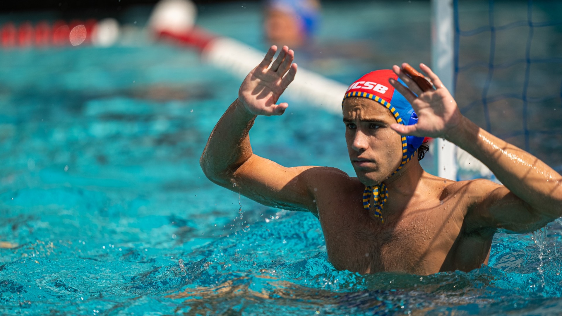 Wyatt Pieretti raises his arms, bent at the elbows, either side of his head to prepare to make a save.
