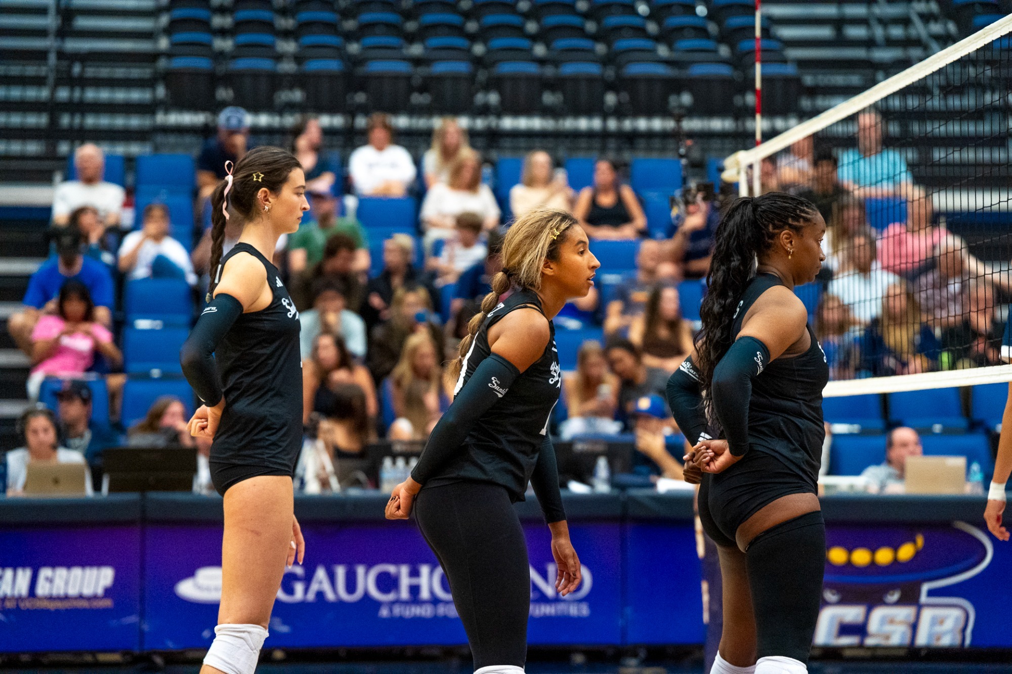 Auburn Tomkinson, Gabi Martinez, and Sandy Thomas line up for the serve
