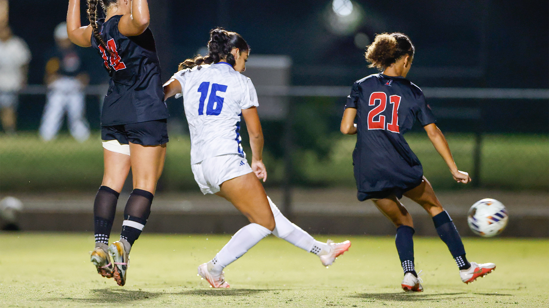 Delilah Vega-Aguilar (#16) take a shot around two defenders. 