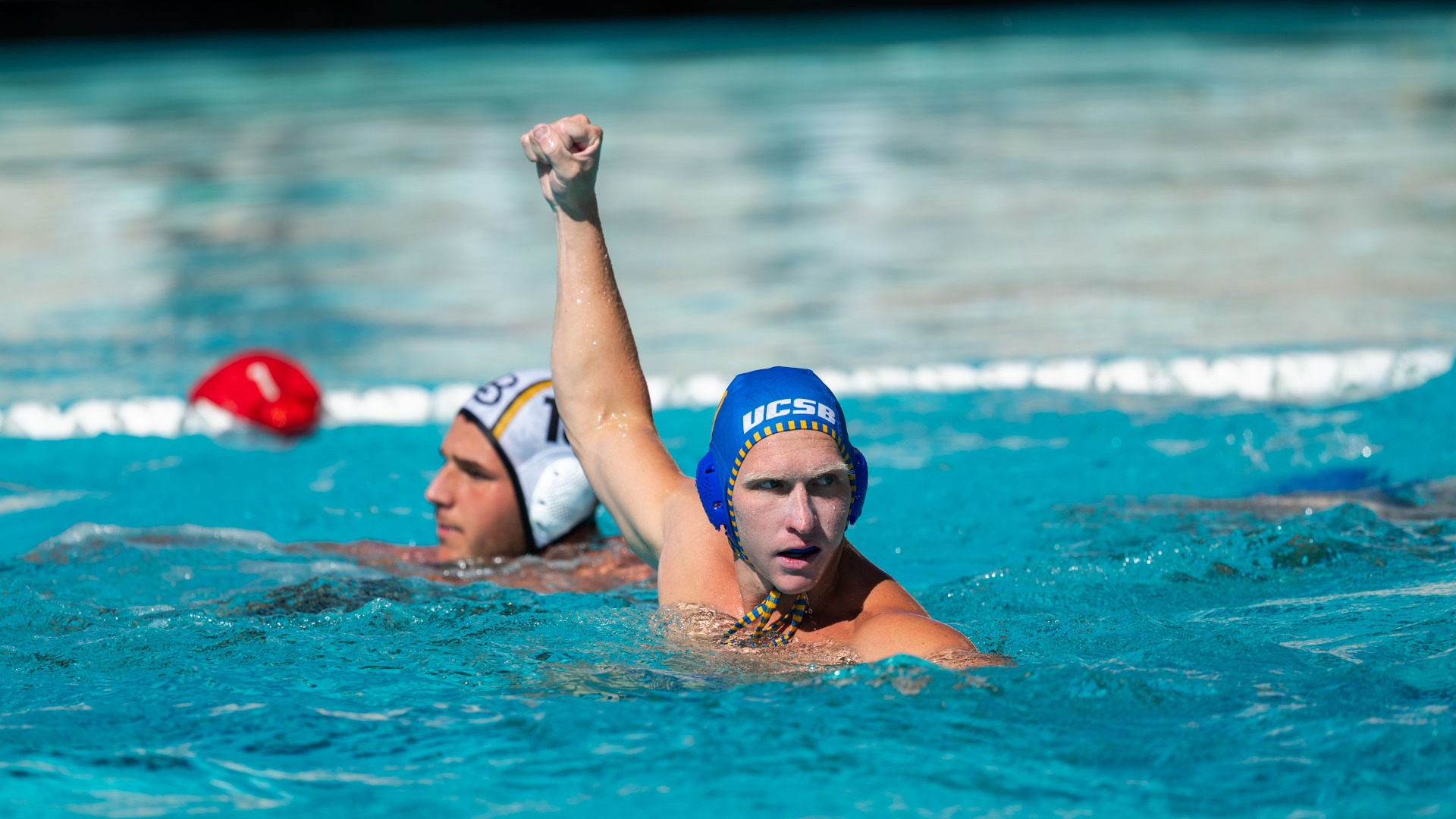 #9 Finn Genc raises a fist and looks back towards his teammates in celebration after a goal