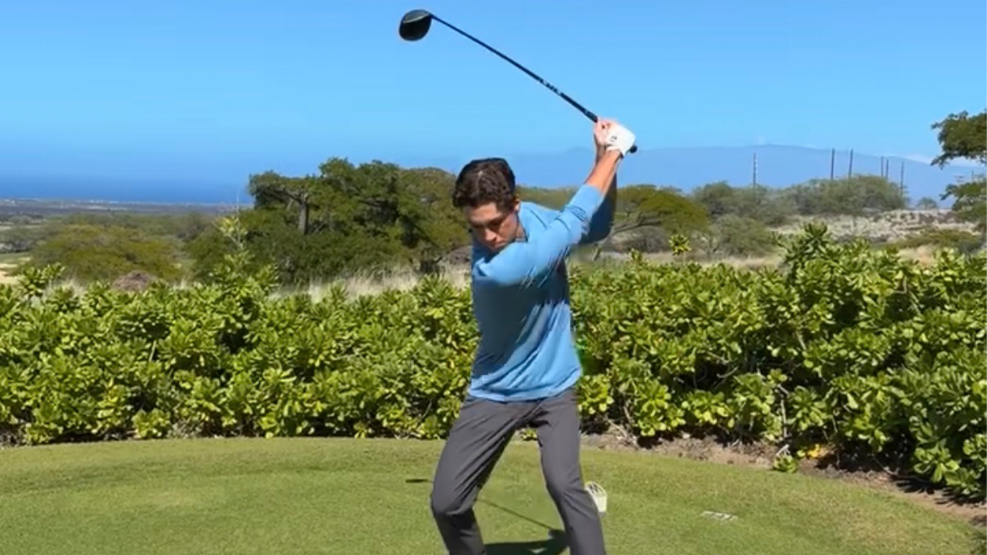 New Golf Recruit Luciano Colan takes his back swing as he gets ready to hit a drive down the fairway.