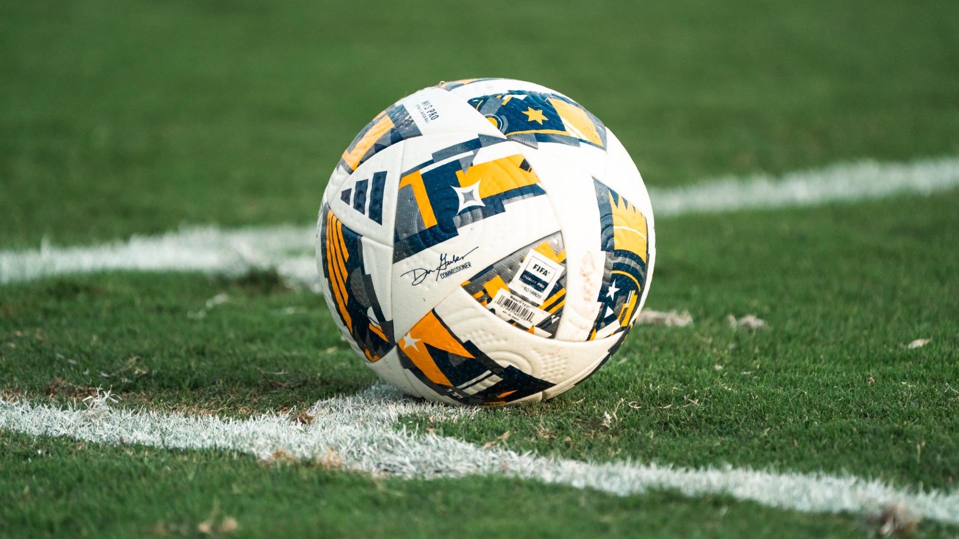 Blue and Gold adidas ball sitting on the corner mark