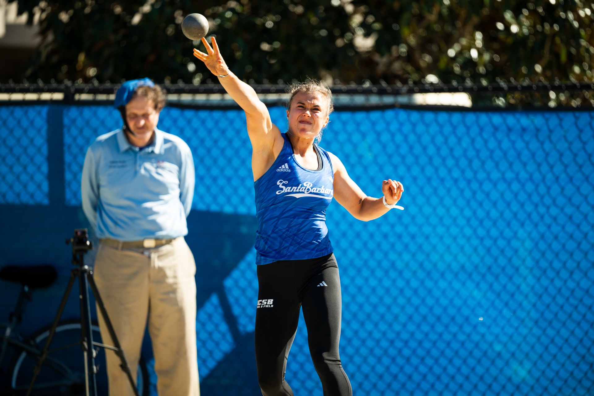 Emma Beck throwing in shot put at Gaucho Relays