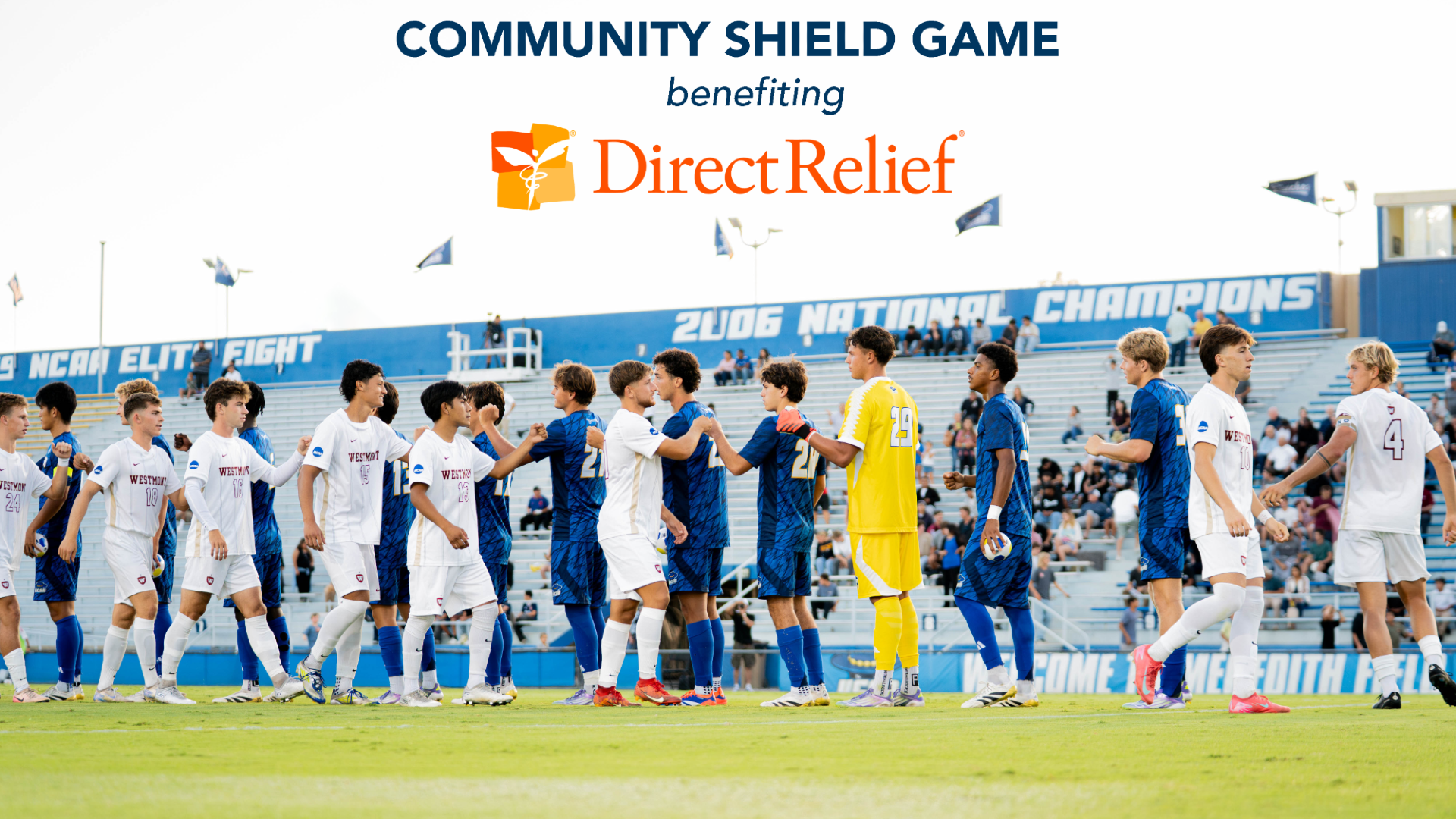 UC Santa Barbara and Westmont men's soccer players exchange sportsmanly fist bumps prior to the 2025 Community Shield game. In the background, we see the text on Harder Stadium's wall that reads 2006 National Champions. Superimposed on the sky above this scene is the text 