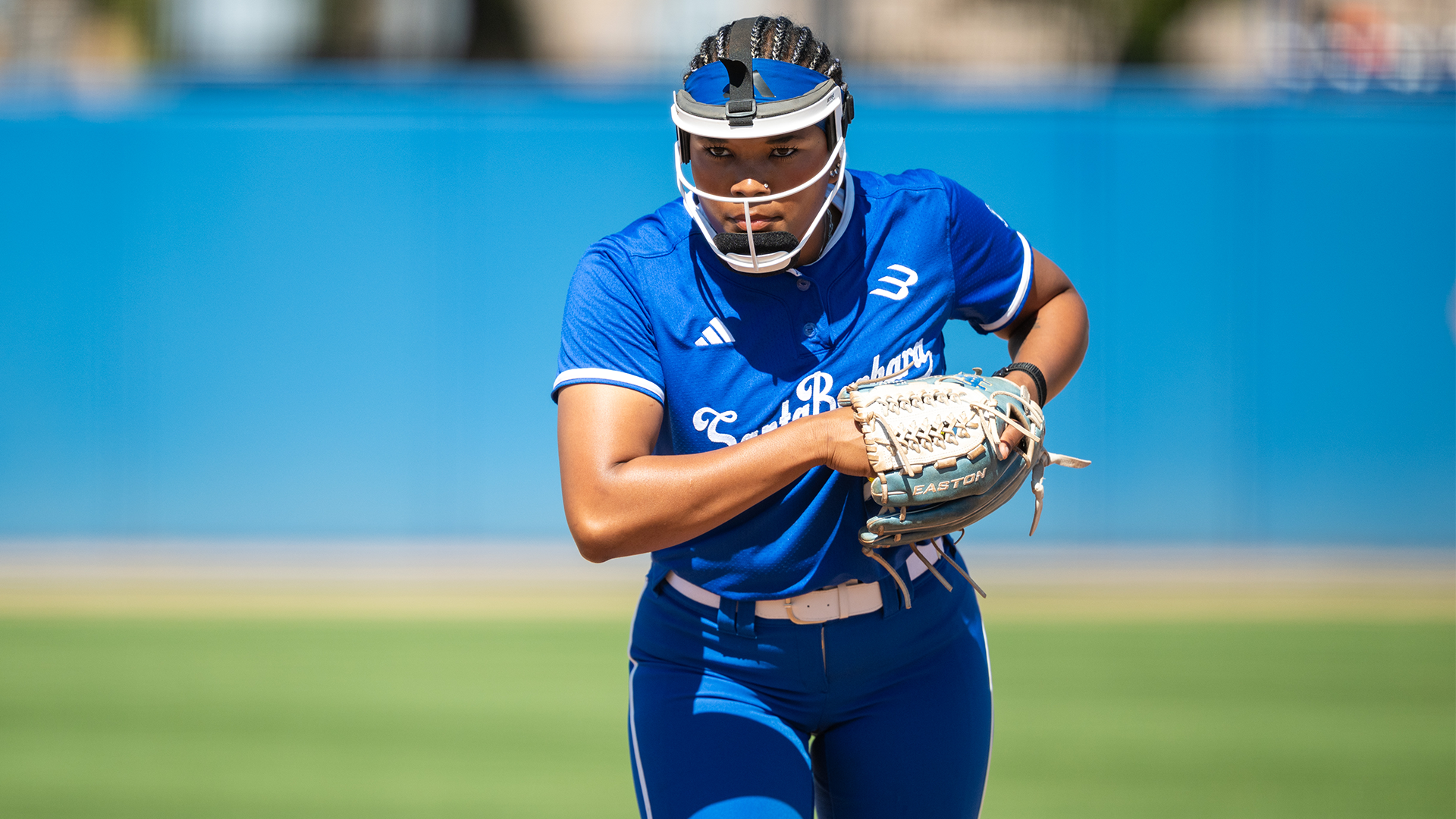 Malaya Johnson crouches down to begin her pitching motion. 