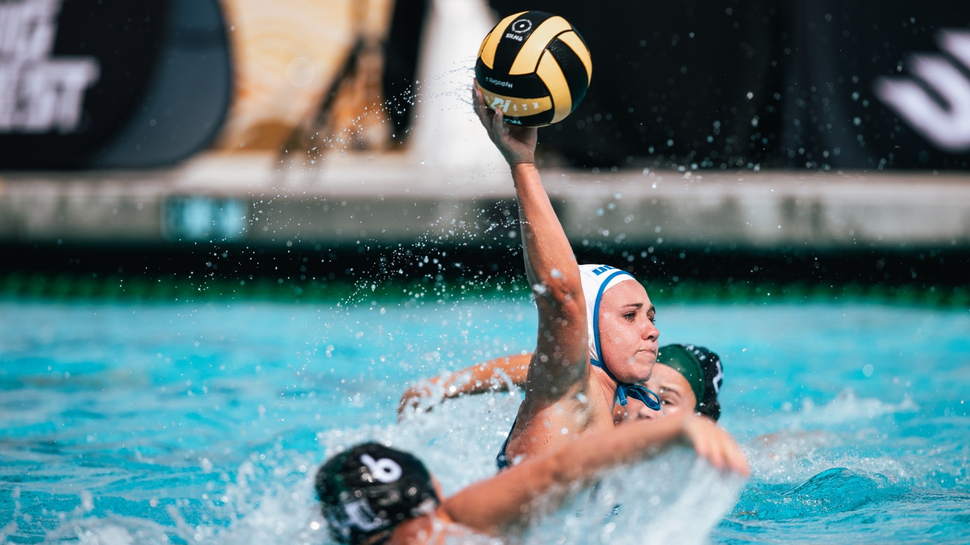 Gigi Rimlinger (#21) lets loose a shot as Hawai'i defenders close in on her from both sides.