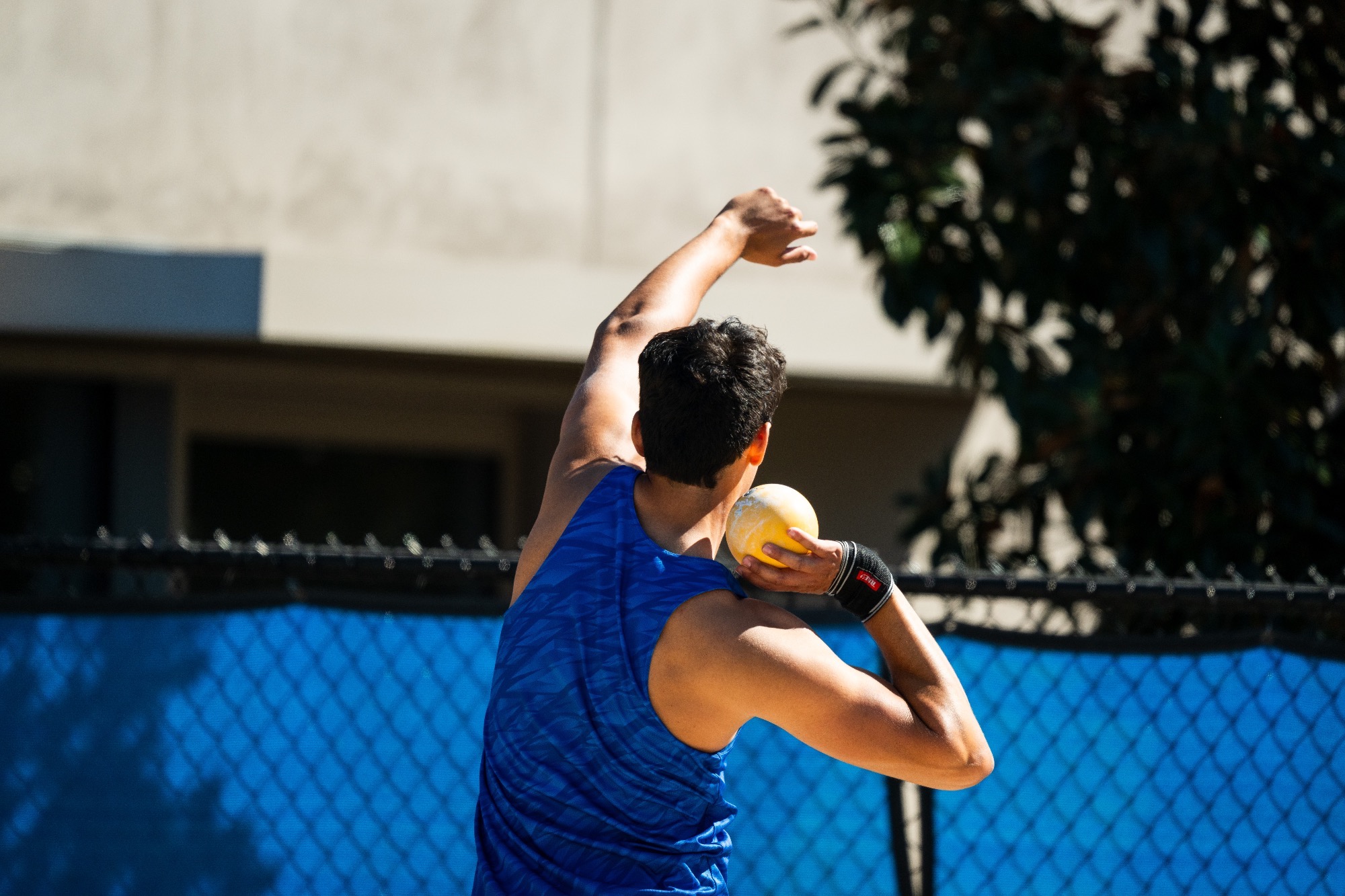 Shaver winding up to throw in shot put 
