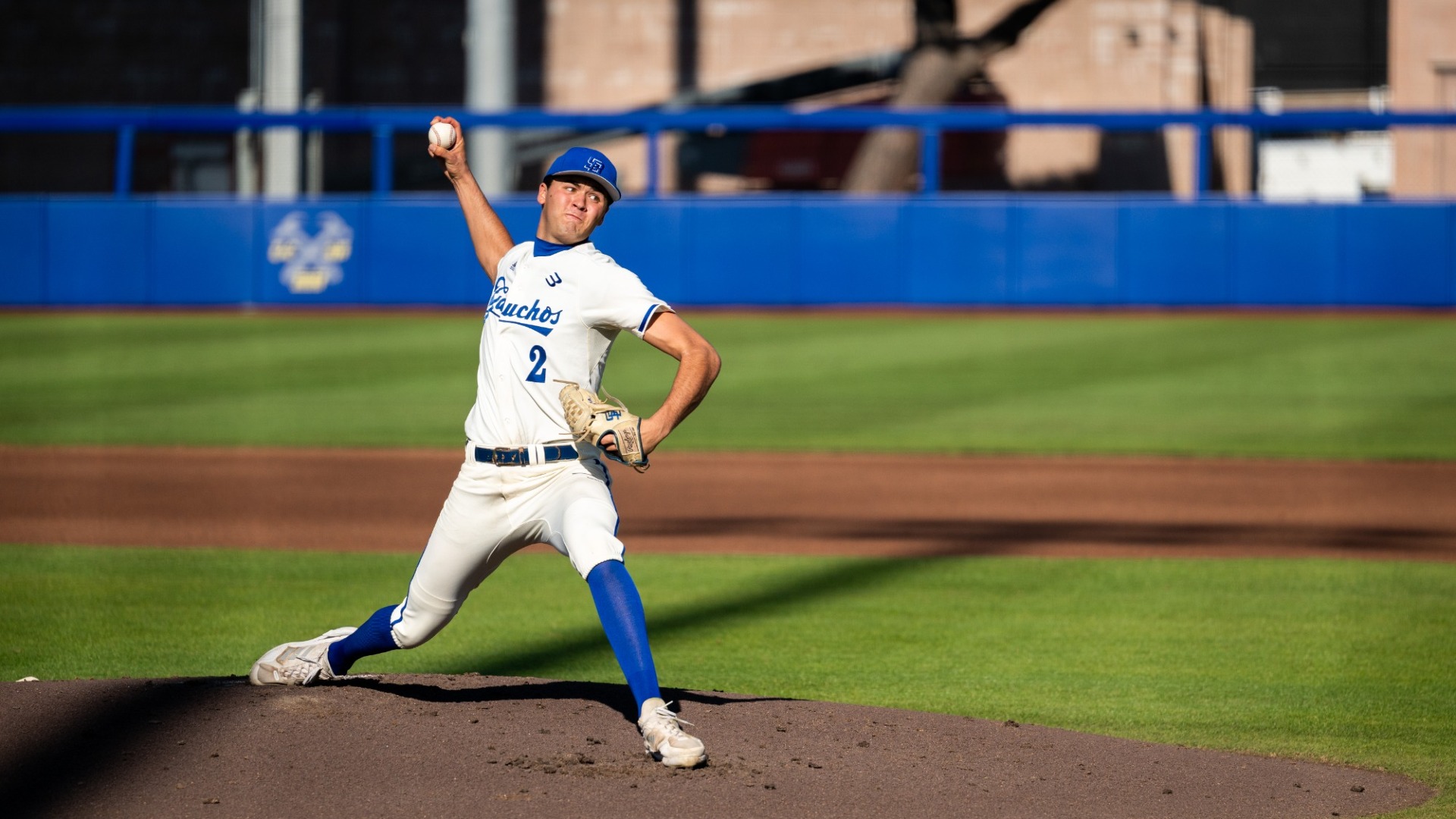 #2 Jackson Flora delivers a pitch against Hawai'i on a clear, sunny day at Caesar Uyesaka Stadium