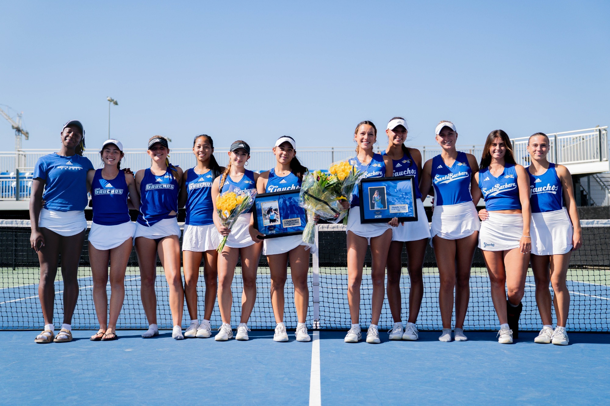 The UC Santa Barbara Women’s Tennis team pose for a picture in celebrating Shanelle Iaconi and Carla Pacot during their final home match against CSUN.