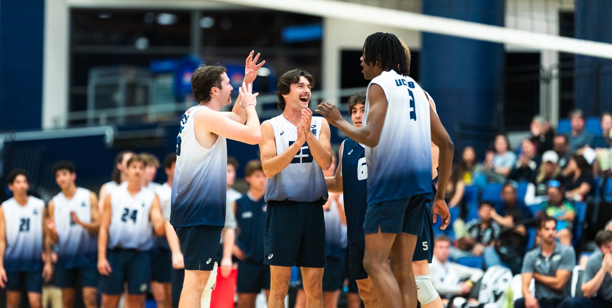 Josh Aruya, Ben Pearson, and Cole Schobel celebrate the winning of a point. 