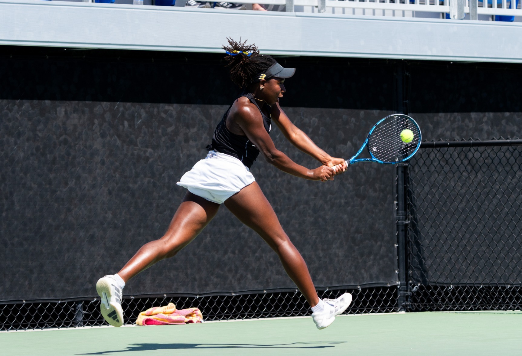 Ekua Youri goes for a backhand mid-stride in the air