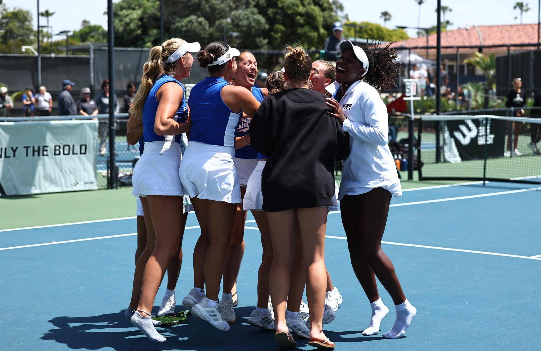 Women's Tennis storm the court and celebrate after Raphaelle Leroux clinches in the Big West Championship Finals