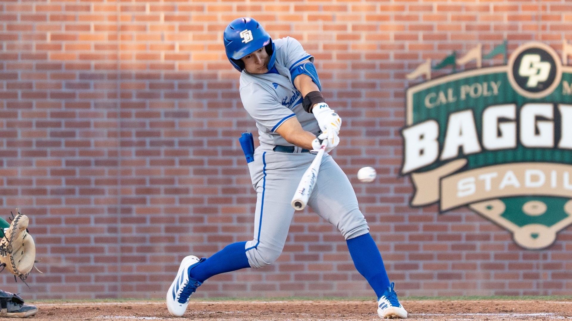 Xavier Esquer (#31) swings at a ball in the Gauchos' game at Cal Poly. We can see his eyes focused directly on the ball, which is just in front of the barrel of his bat, about to be sent rapidly in the other direction.