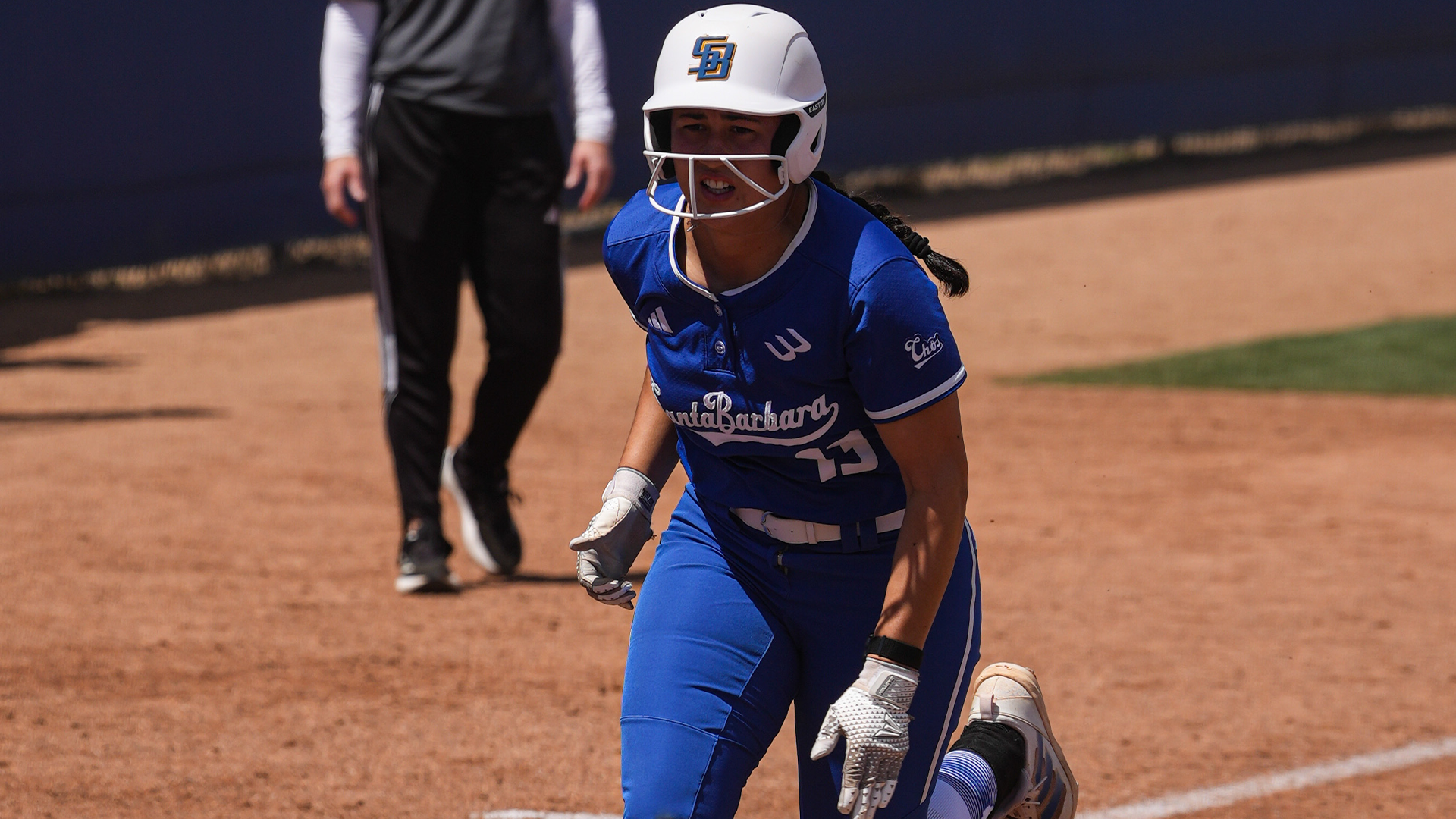 #13 Ella Myers runs home to score a run against Hawai'i in game two of the series.