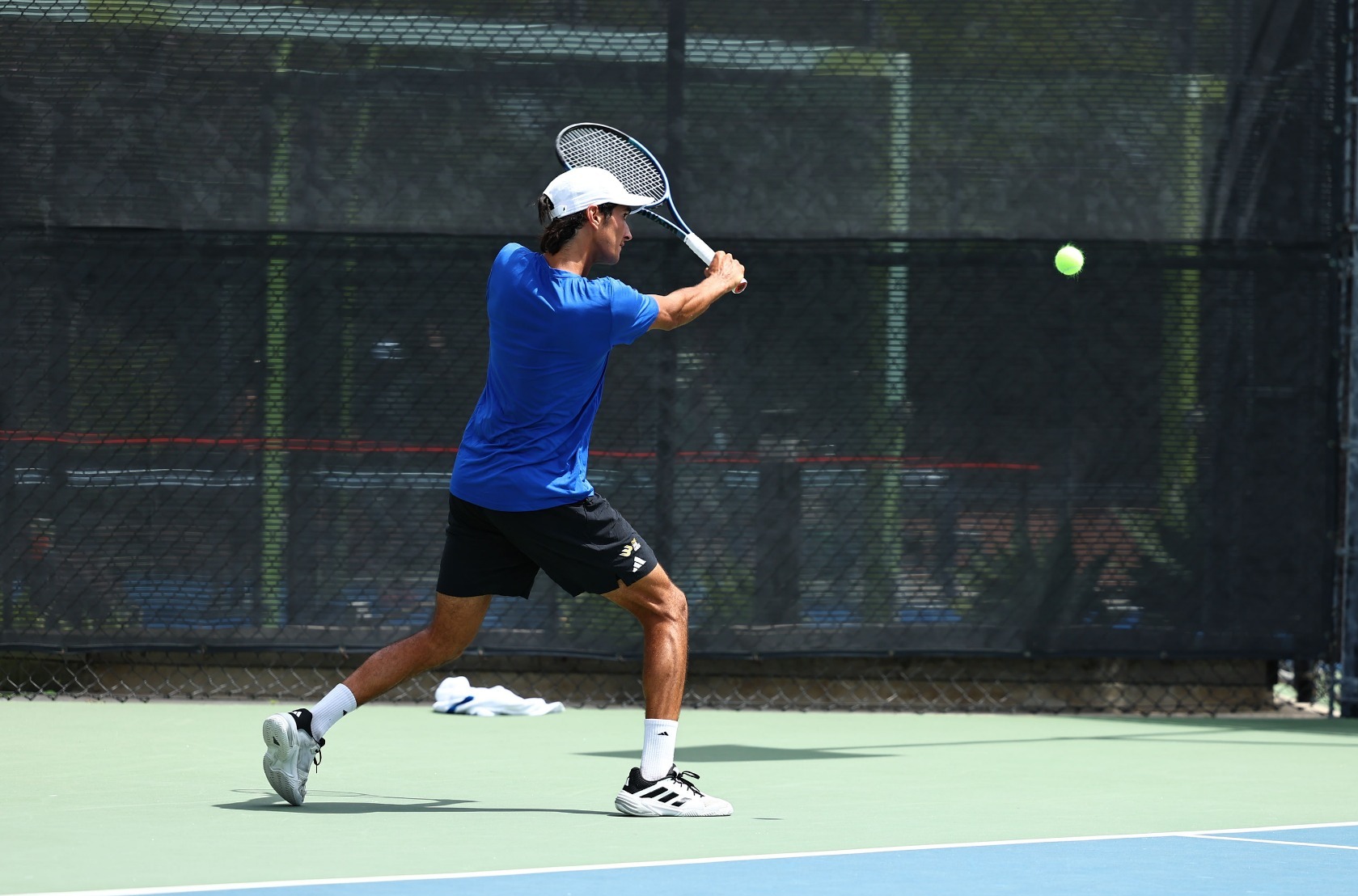 Diogo Morais hits a one hand backhand slice