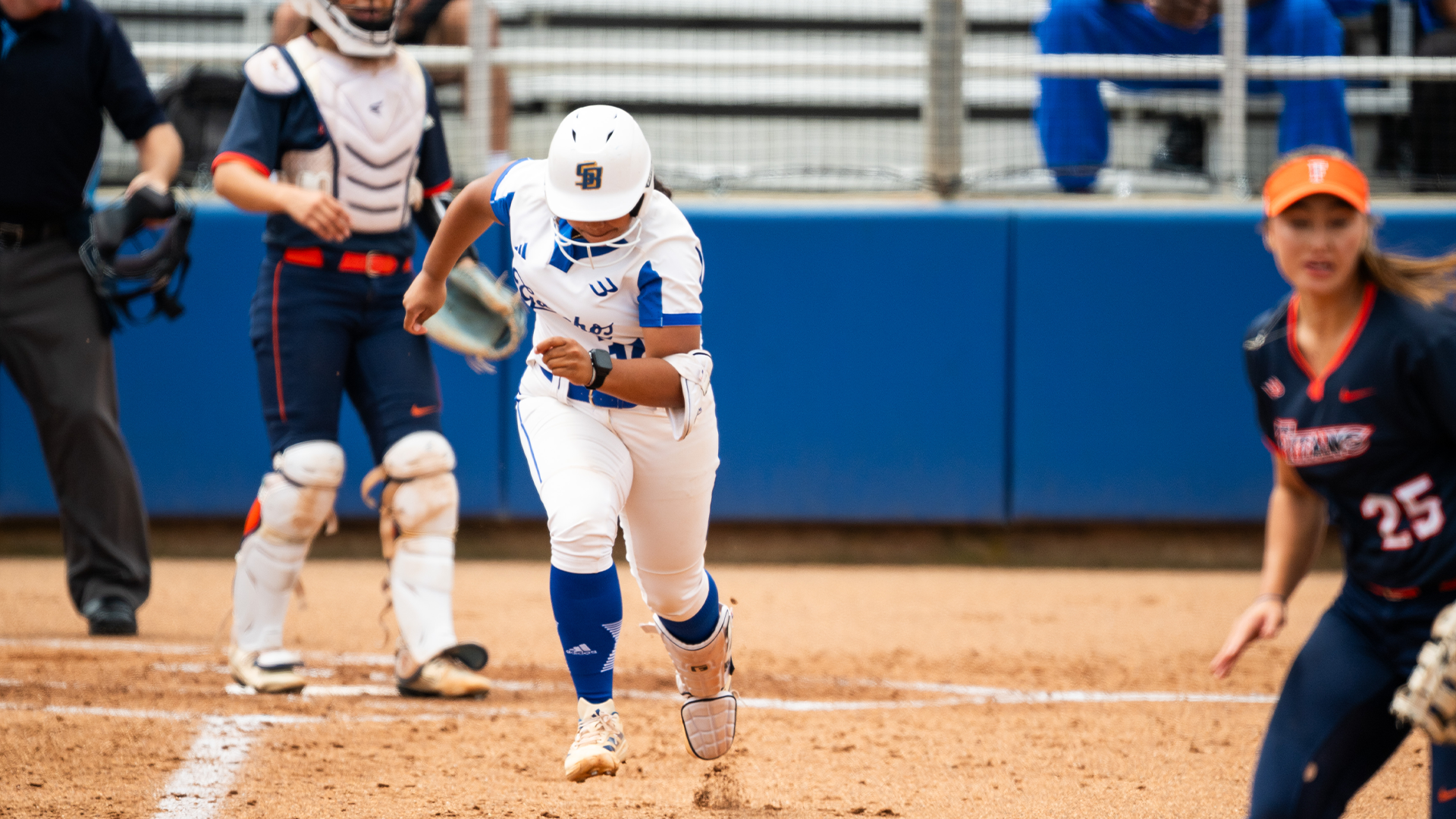 Delaina Ma'ae (#32) runs out a base hit.
