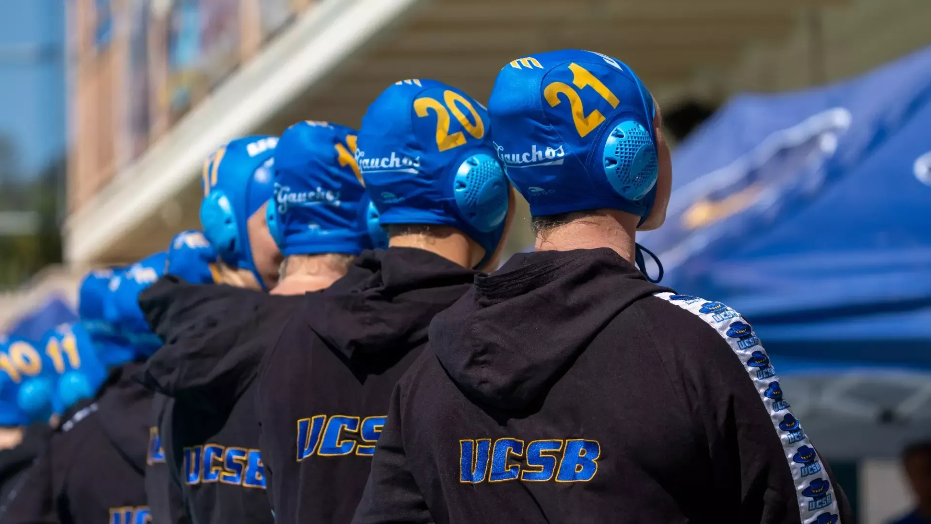 A photo of Gaucho Women Water Polo players lined up for the National Anthem