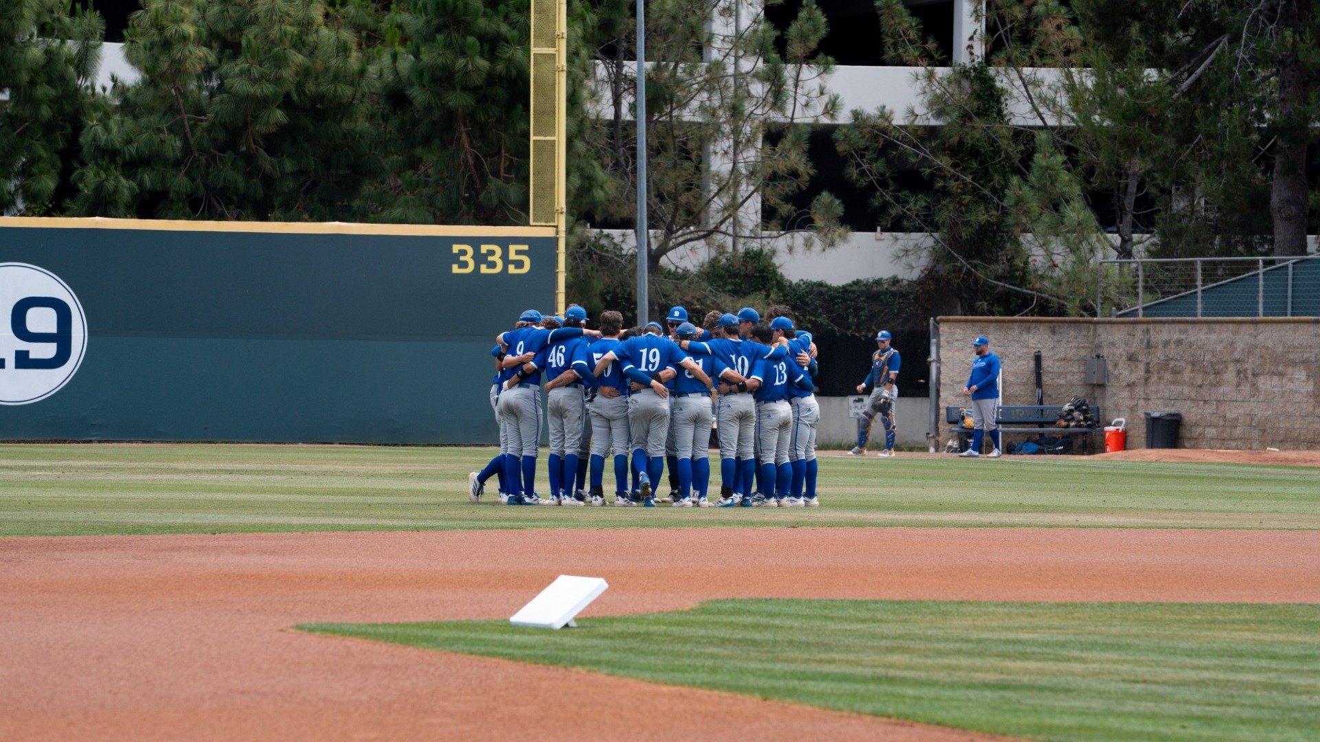 The UC Santa Barbara Baseball team huddles together in right field at Anteater Ballpark before a Big West Championship elimination game.