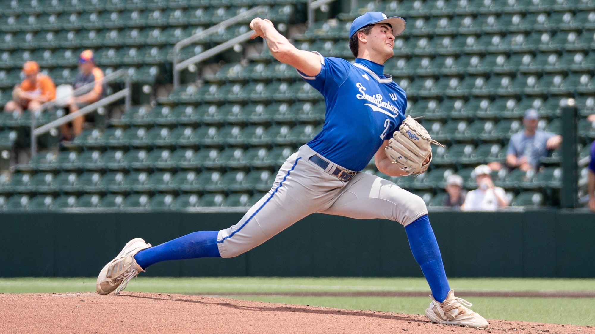 A view from the dugout as Jackson Flora delivers a pitch at the 2026 Austin Regional. The look on his face and the veins popping in his arm belie the effort he is exerting