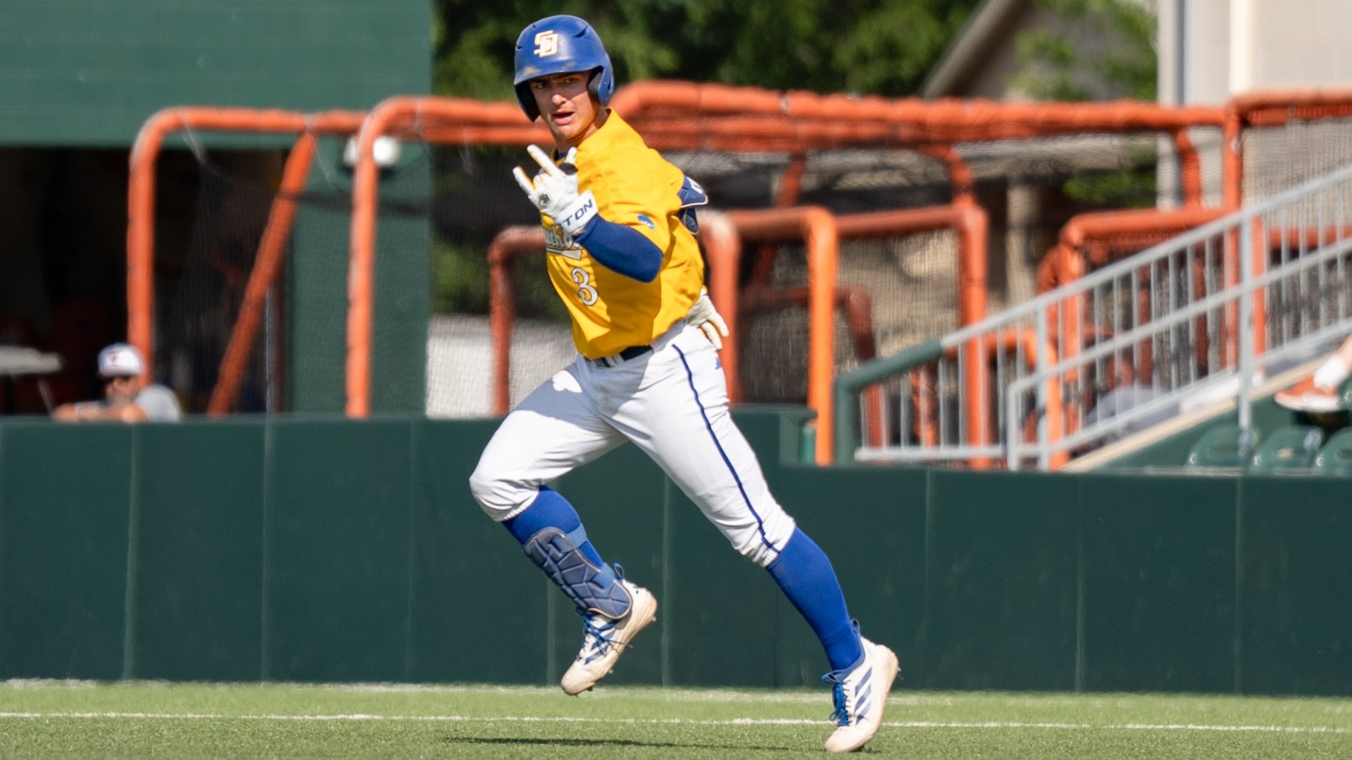 Rowan Kelly looks in towards his dugout as he rounds the bases after hitting a home run against Texas