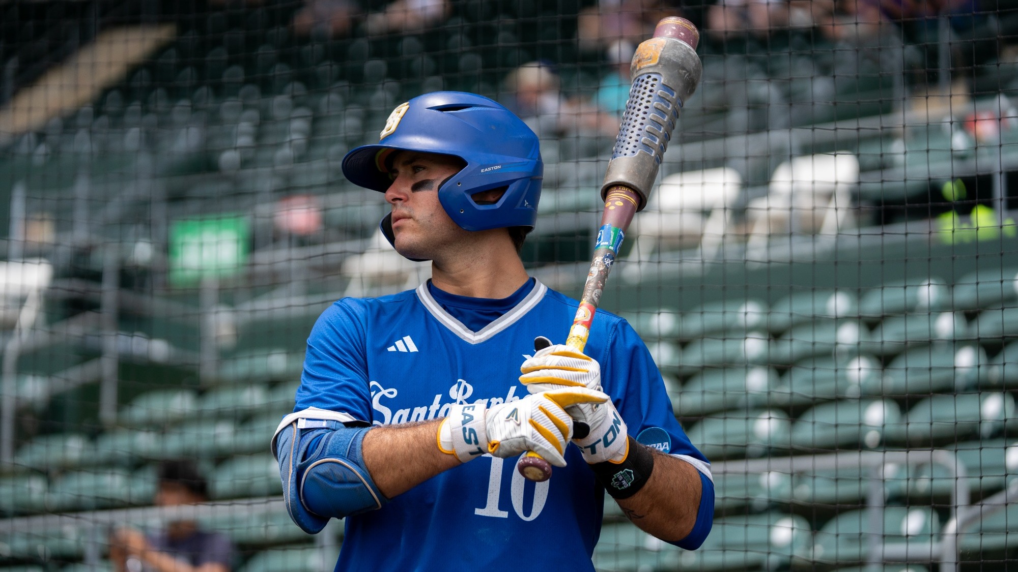 Liam Barrett stands in the on-deck circle at Texas with a weight on the barrell of his bat