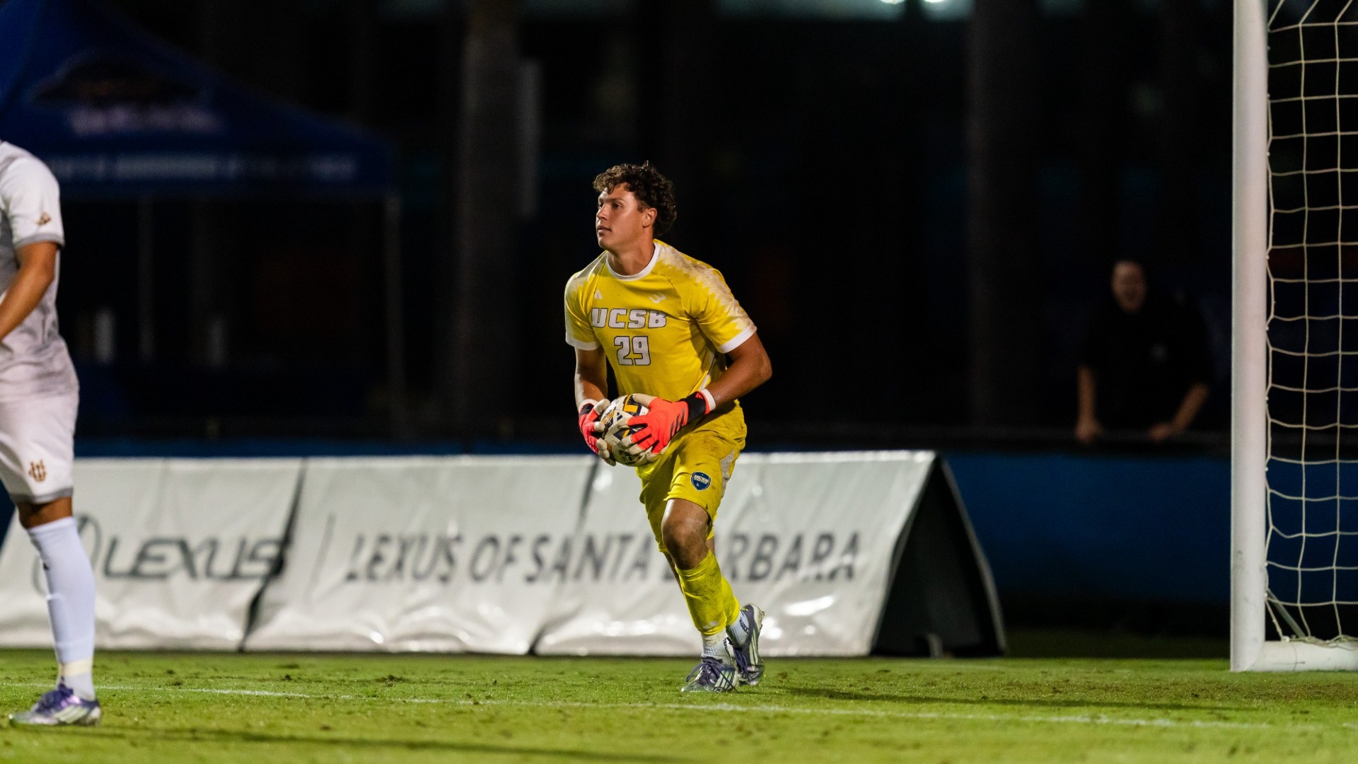 Owen Beninga looks for a pass downfield with the ball in his hands as he starts to walk away from his goal