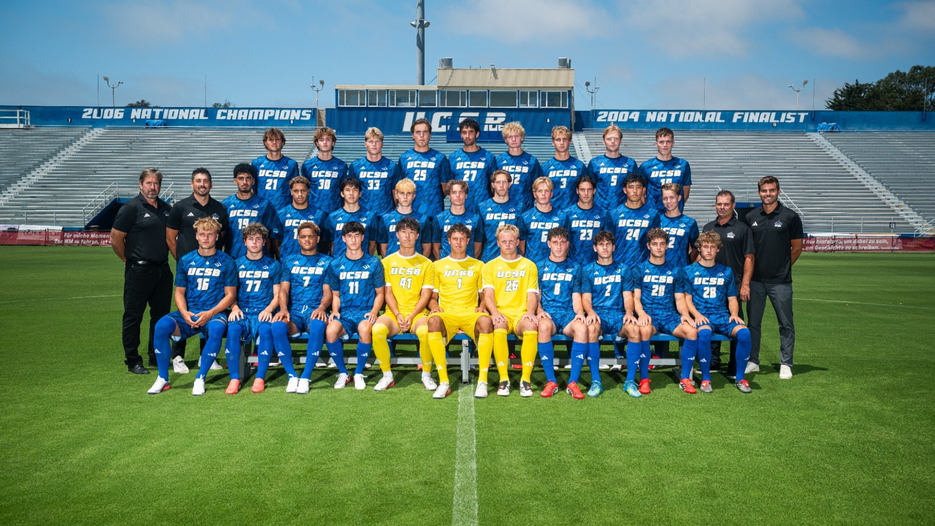 The UC Santa Barbara Men's Soccer Team's 2026 team photo, taken on the field at Harder Stadium, with the press box in the background