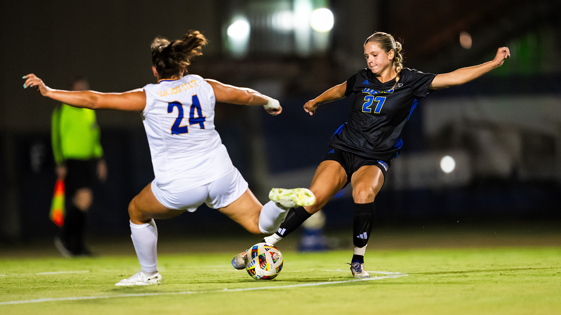 Lacey Harnish (#27) gets ready to clear a ball near the penalty box as a San Jose State player runs towards her.