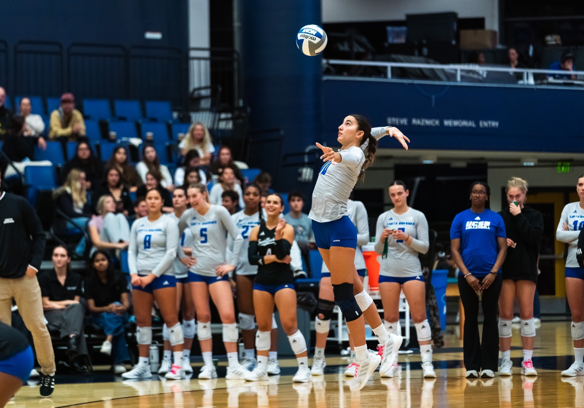 Kate Martin serving the ball