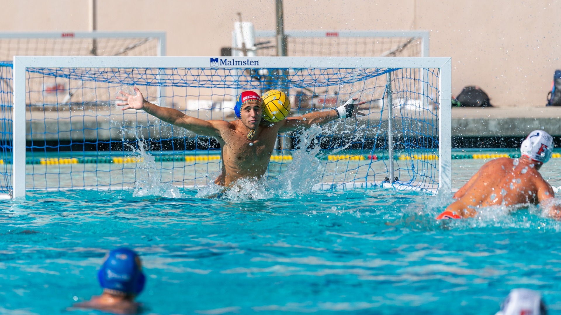 #1 Wyatt Pieretti lunges out of his goalmouth and spreads his arms wide to try and stop a five-meter penalty shot. The ball hits his shoulder instead of the back of the net.