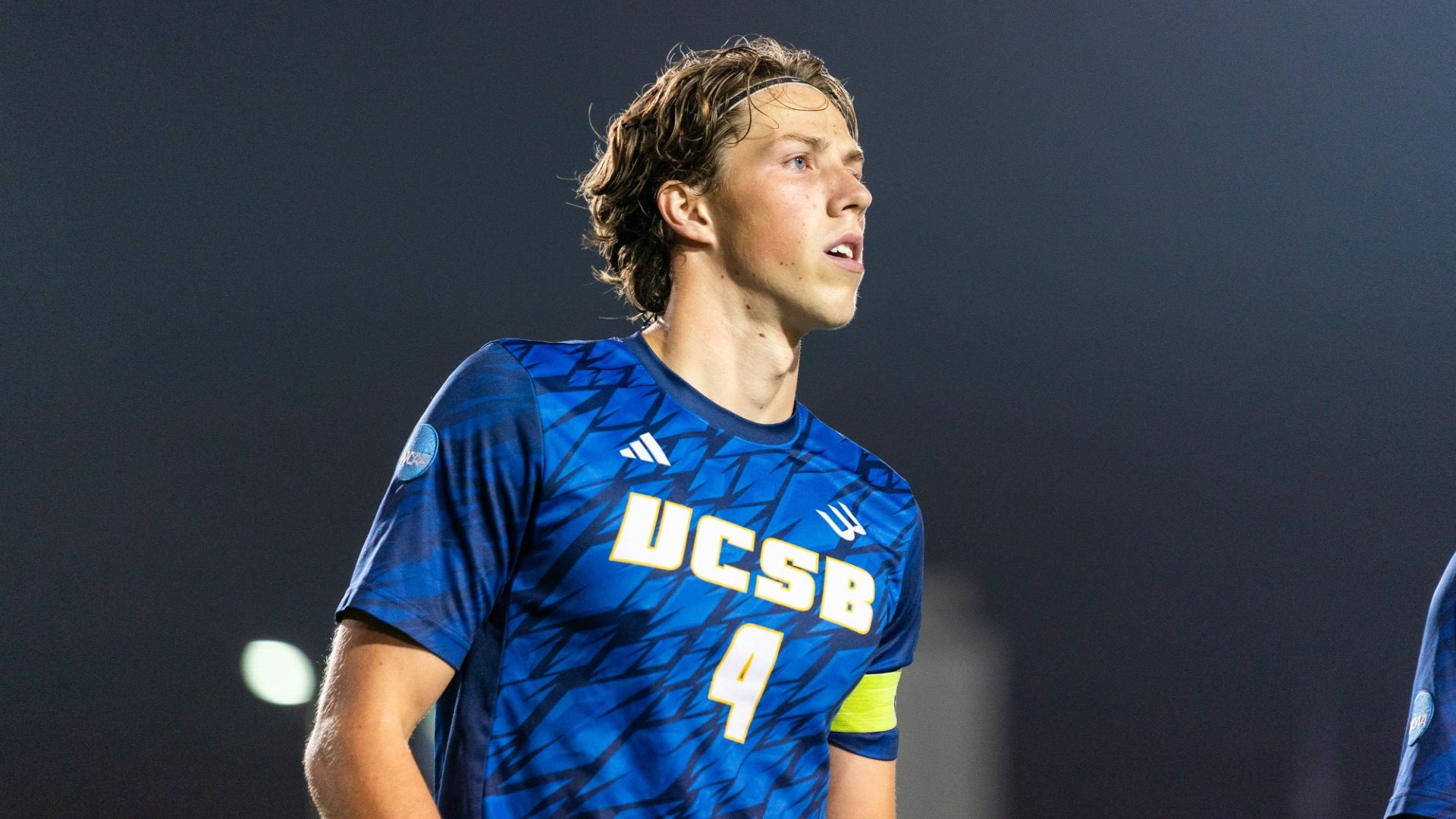 A shot of Calle Mollerberg against the black backdrop of the night sky as he stands in the pregame lineup for The Big West Semifinal