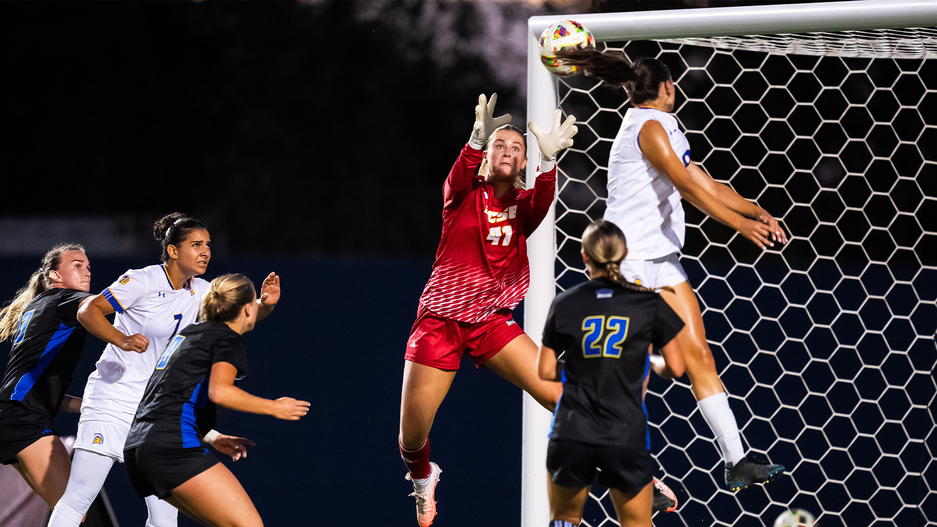 Maddie Buckley (#41) jumps for a ball coming in on net to make a play.