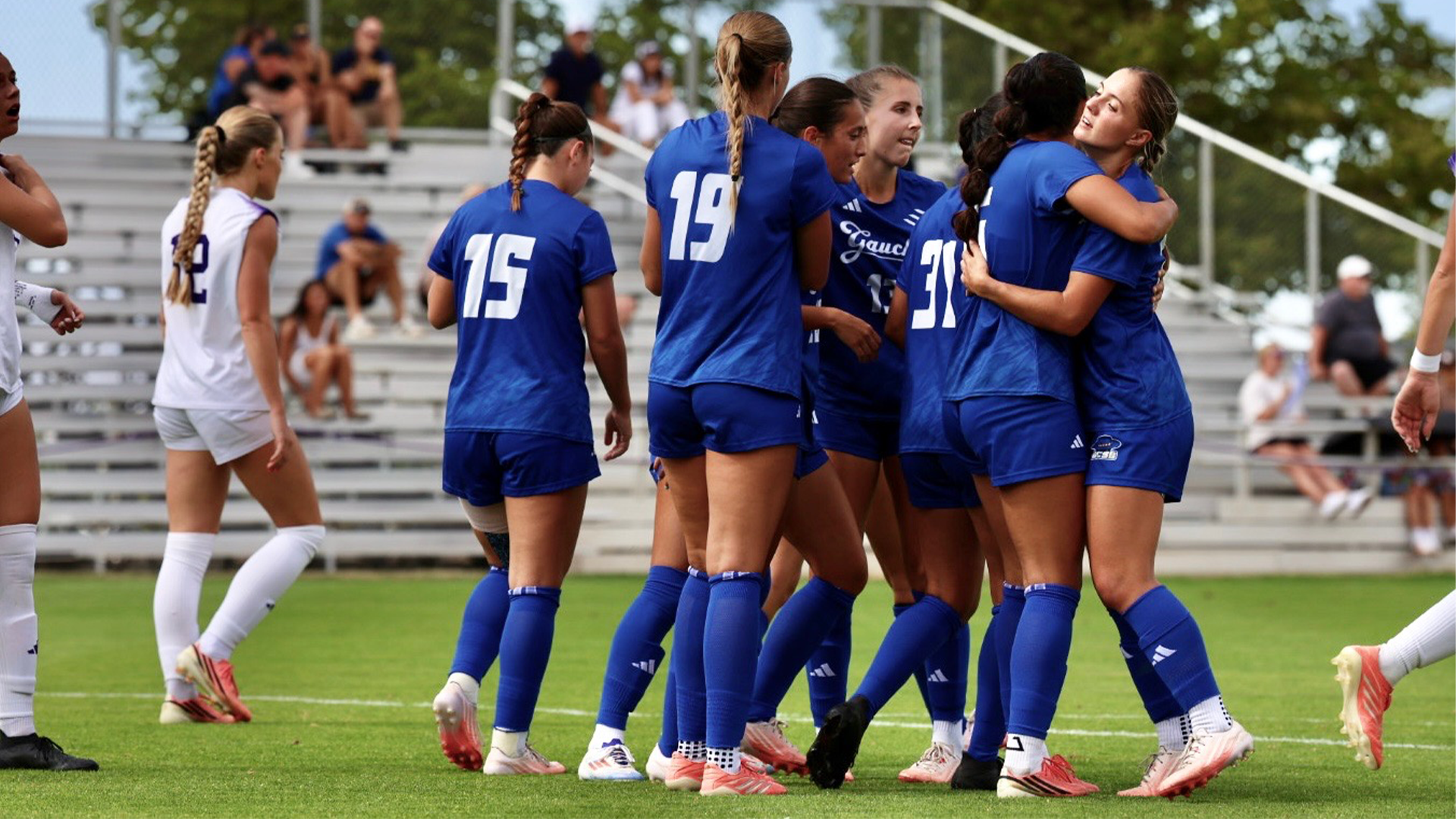 The Women's Soccer team celebrates by hugging each other after a goal against Weber State.