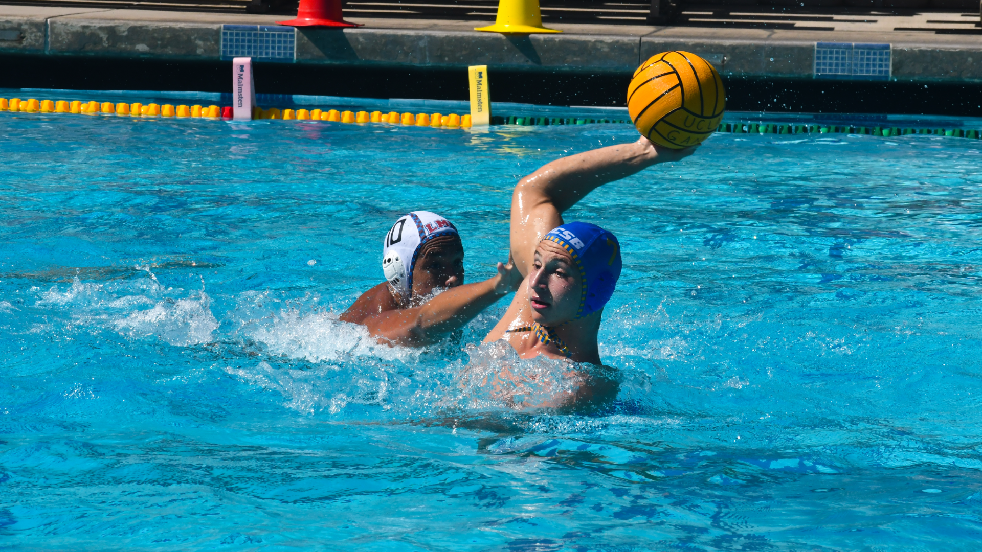 #7 Luigi Canepa raises his arm and prepares to throw the ball as an LMU defender closes in from the left of the frame