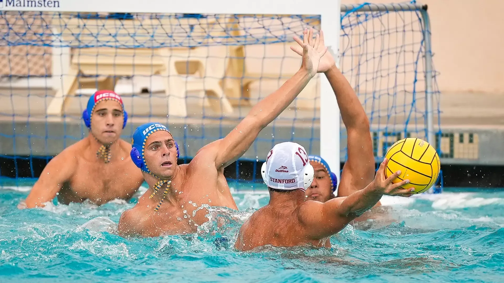 #4 Dash D'Ambrosia raises his left arm to try and block a Stanford attacker as he winds up to shoot.