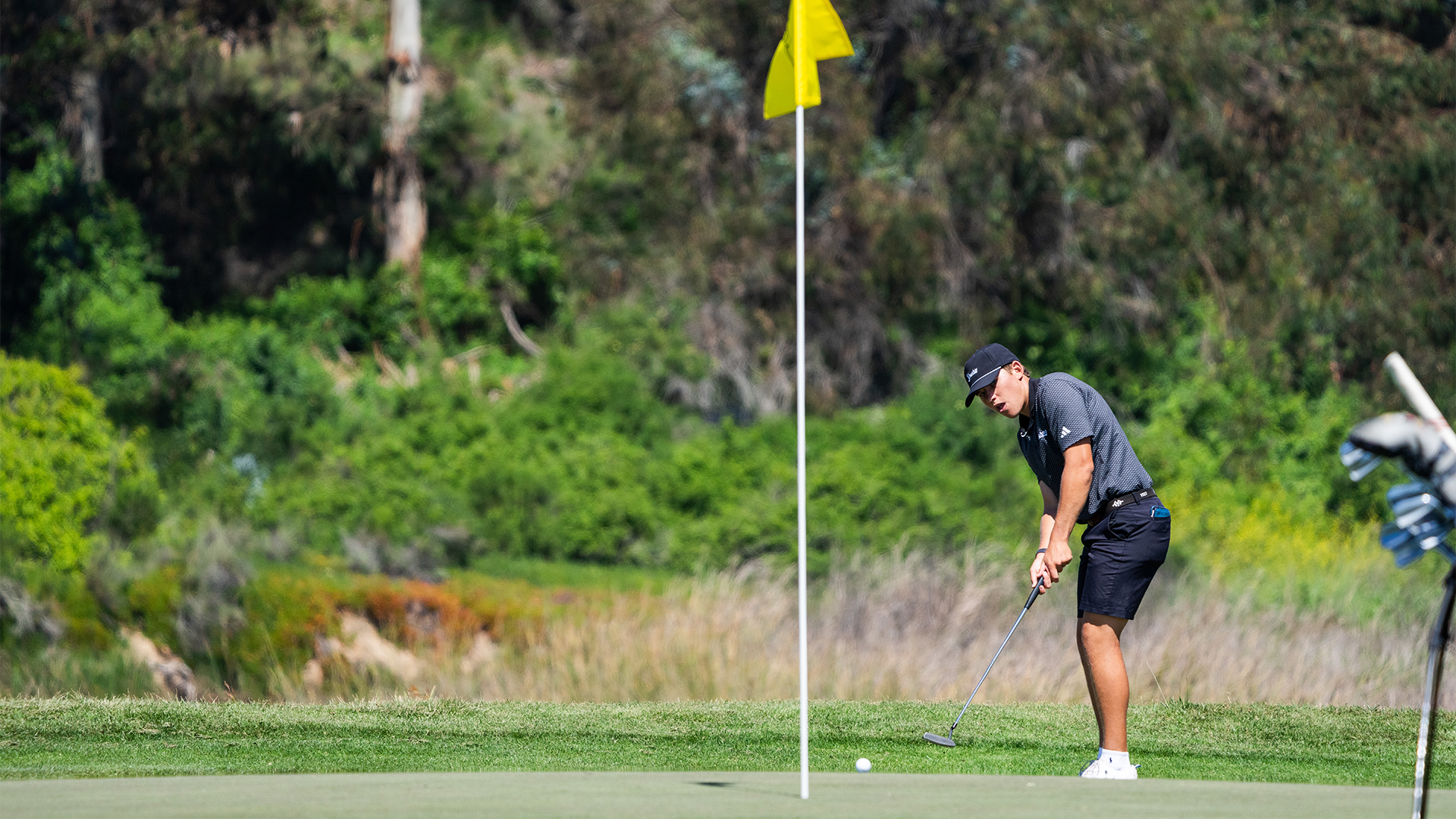 Nick Waldock watches his ball after hitting a putt towards the hole. 