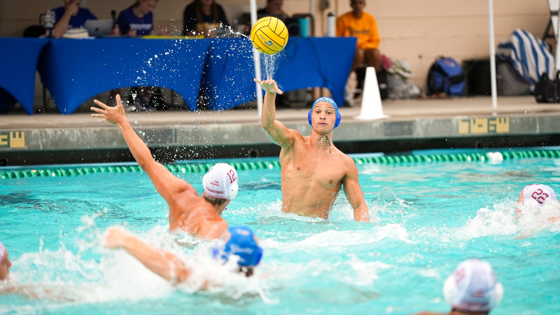 Luigi Canepa raises his entire torso out of the water as he starts to lob a pass toward a teammate.