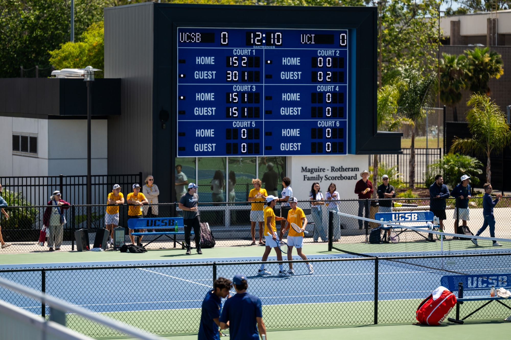Diogo Morais and Lorenzo Brunkow come together and celebrate a point with a high five against UC Irvine; the crowd behind cheers them on.