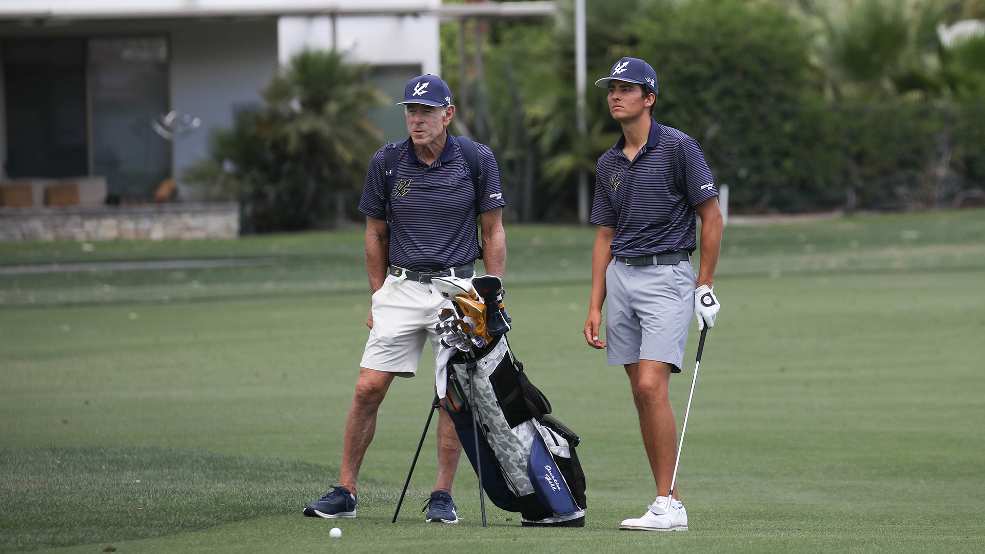 Justin Gill and assistant coach Bill Cohn sizing up a shot