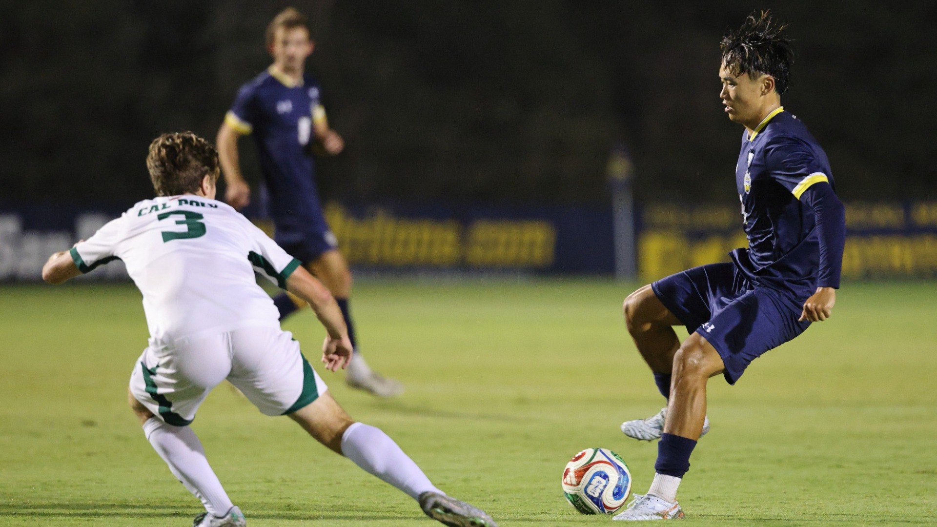Sean Ueda pulling the ball back away from a defender
