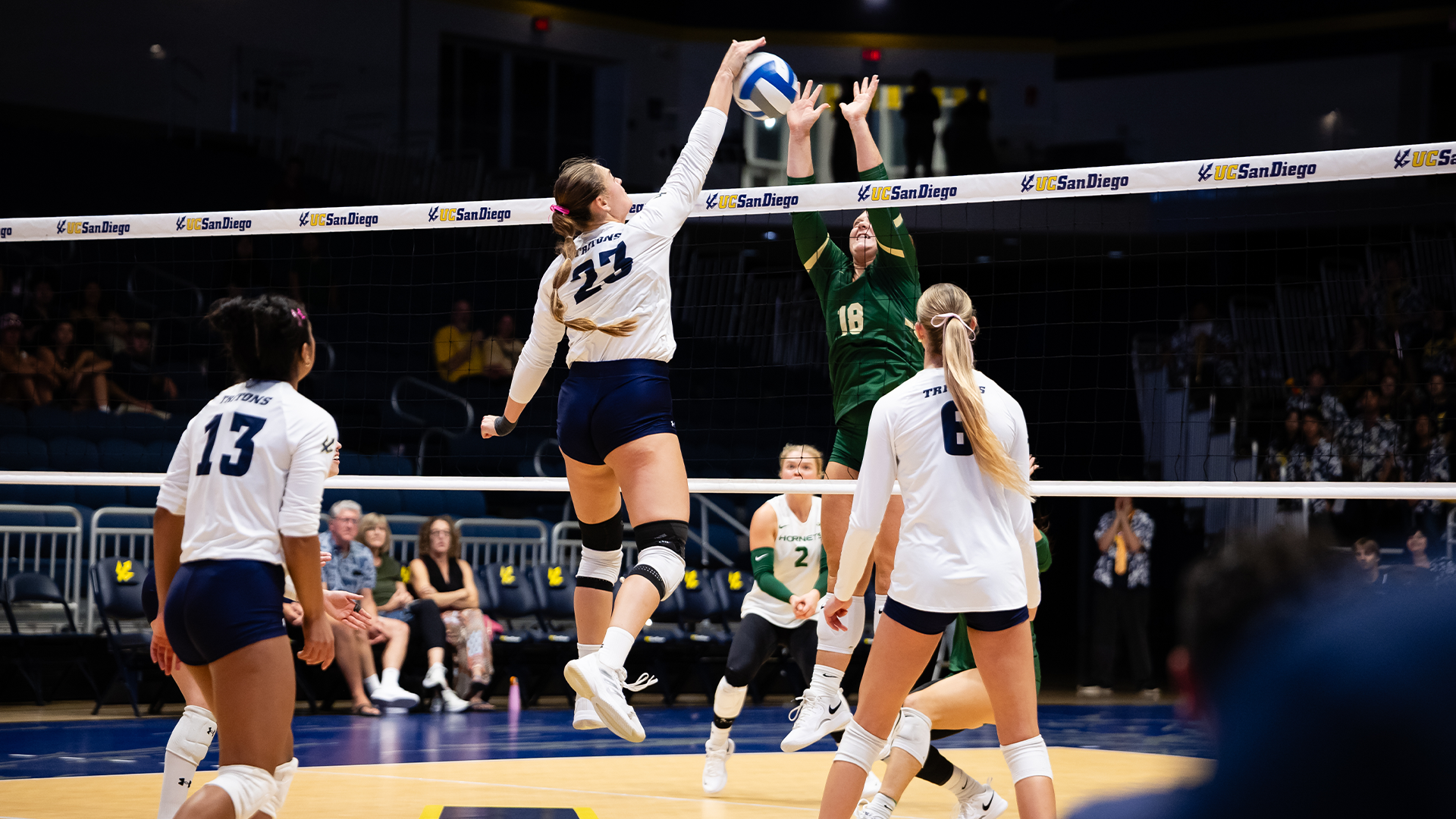 Lucia Barroso hits at net against Sacramento State block
