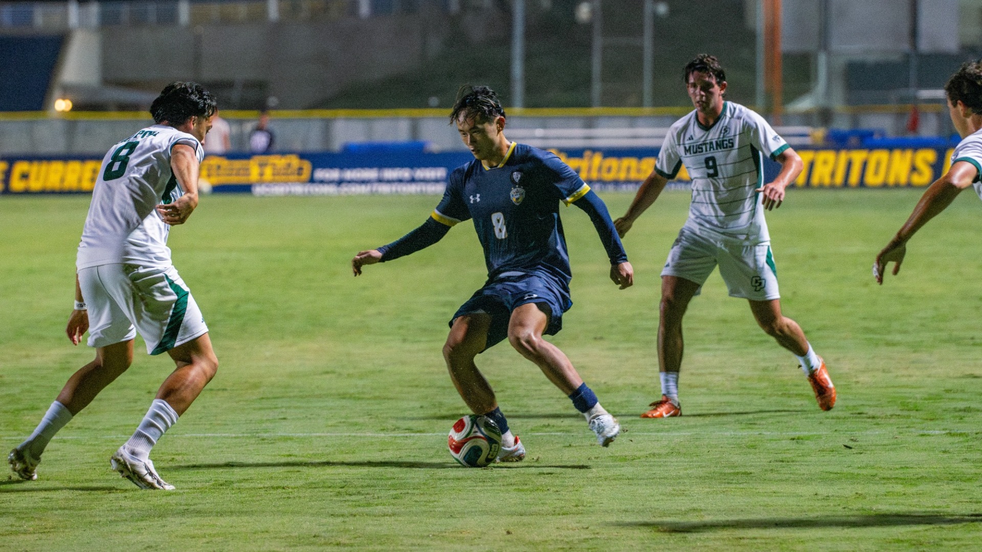 Sean Ueda dribbling with an opponent in front