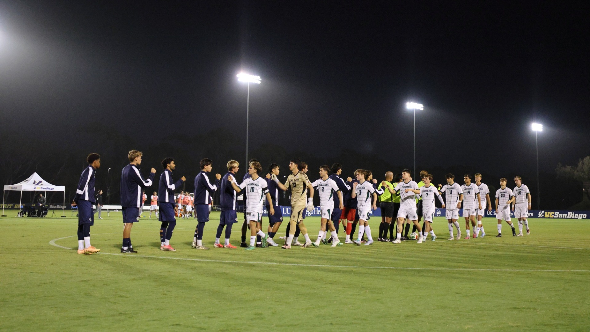 UC San Diego men's soccer in a handshake line with Cal Poly before a match
