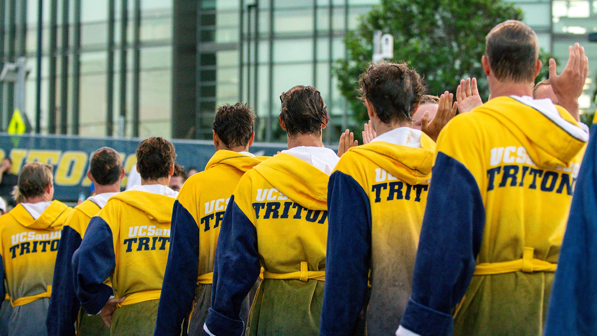 Team in robes lined up on pool deck