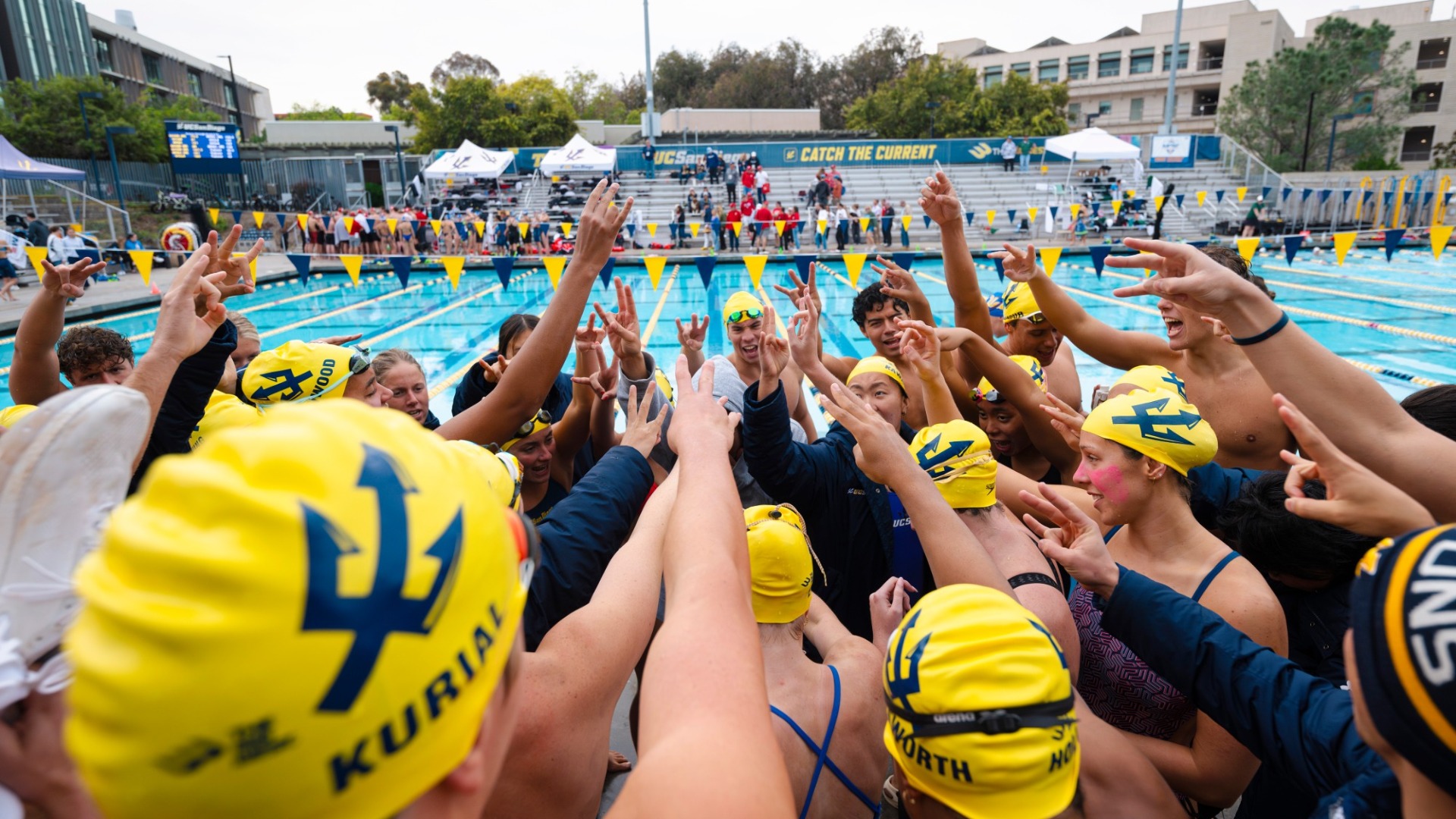 Swim team huddle in Canyonview Aquatic center before meet