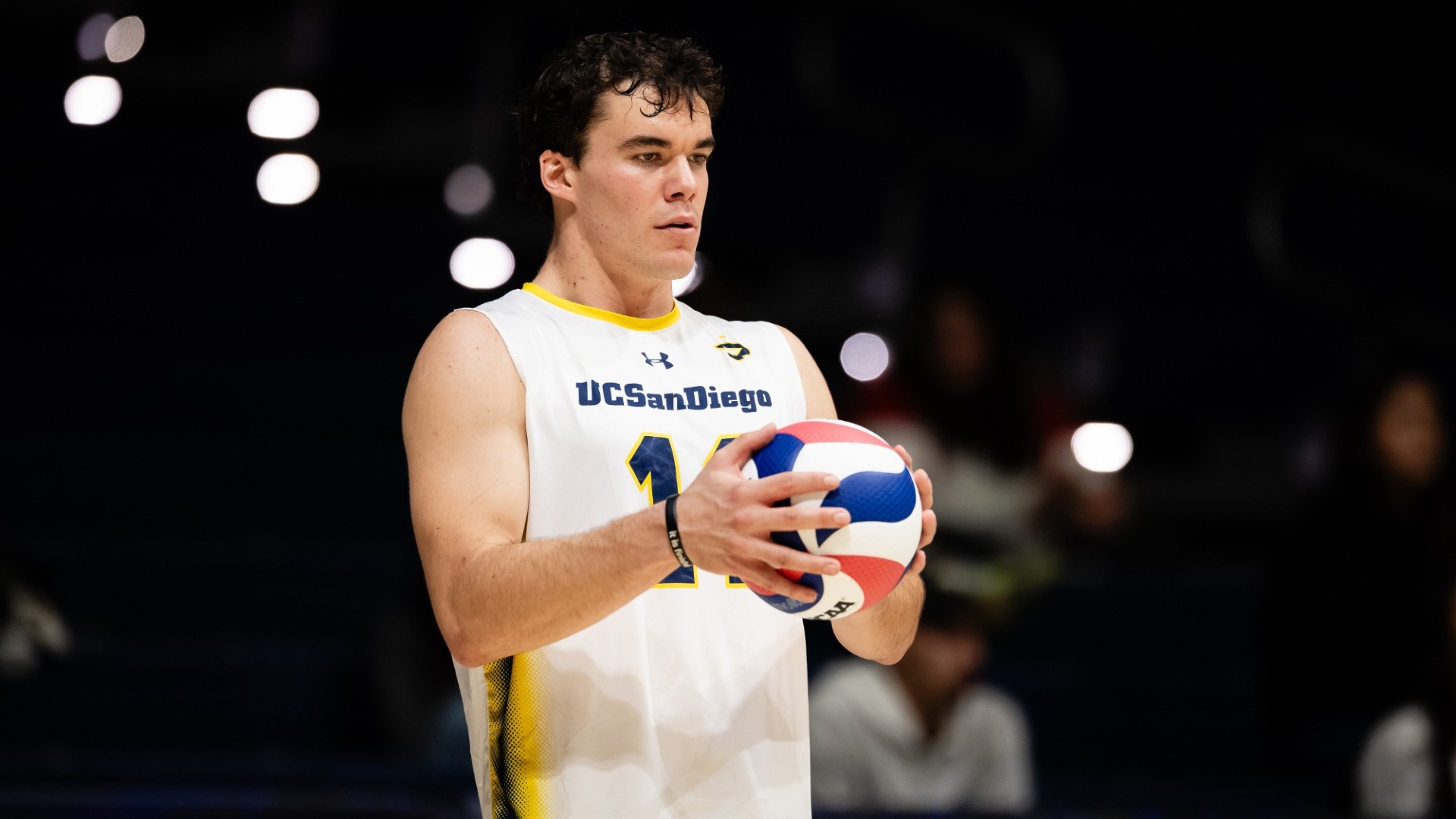 John Luers holding a volleyball