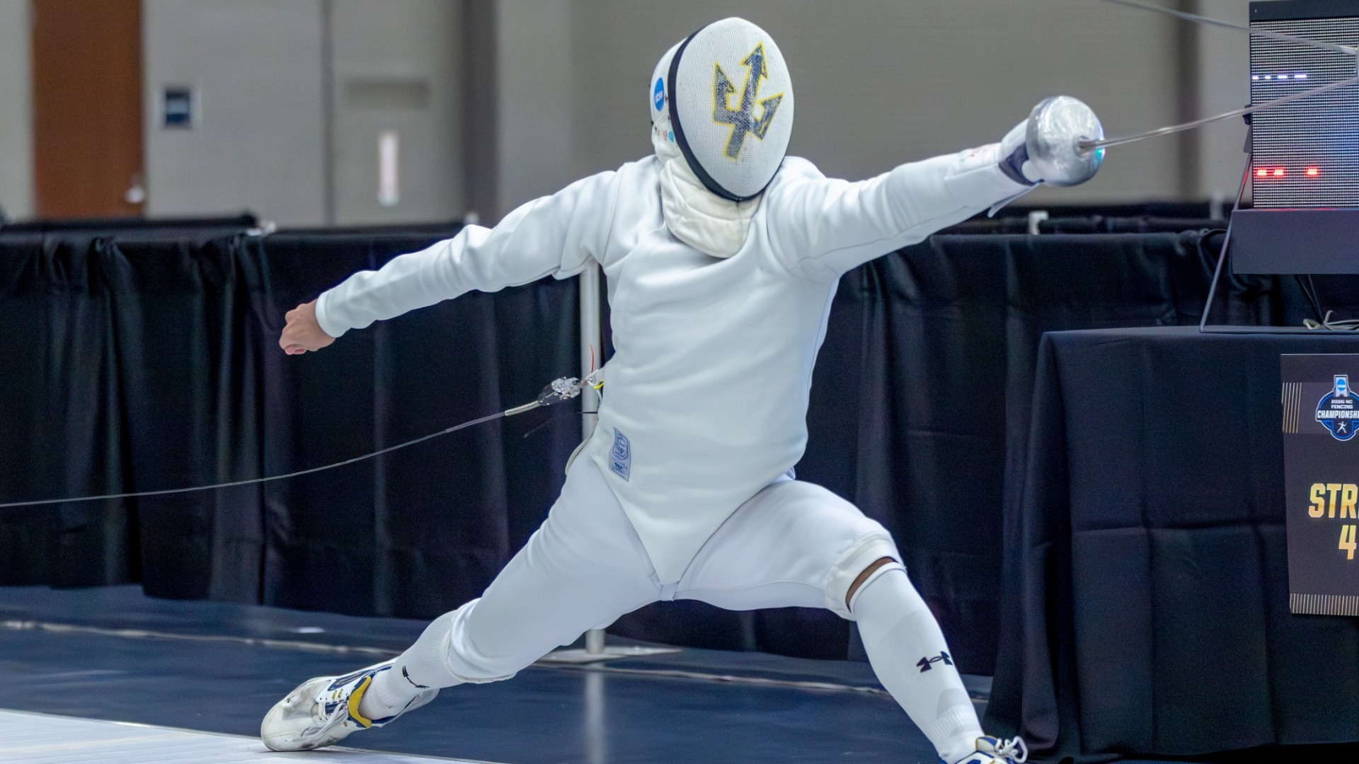 Nurzhan Abzhanov lunging forward with his epee
